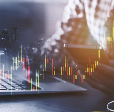 A trader studying charts at the desk